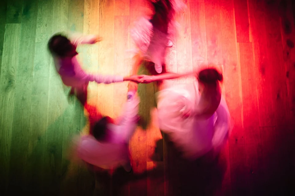 A couple dancing in colourful light at Kimberley Hall
