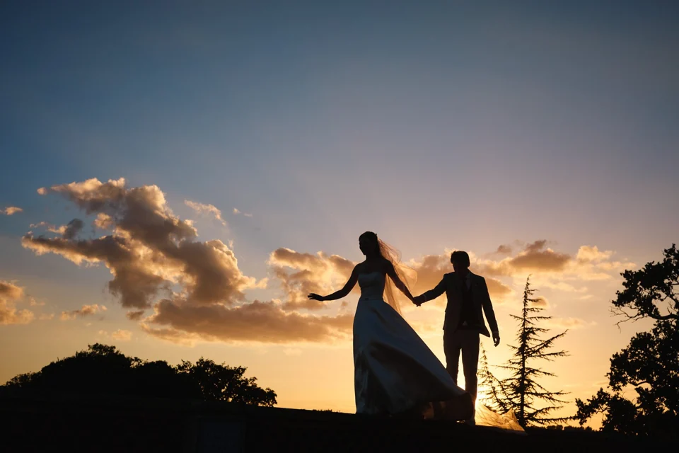 A couple silhouetted against the sunset at Kimberley Hall