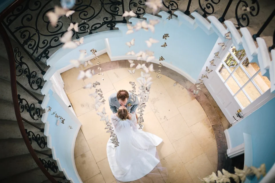 A newly married couple beneath the curved staircase at Kimberley Hall