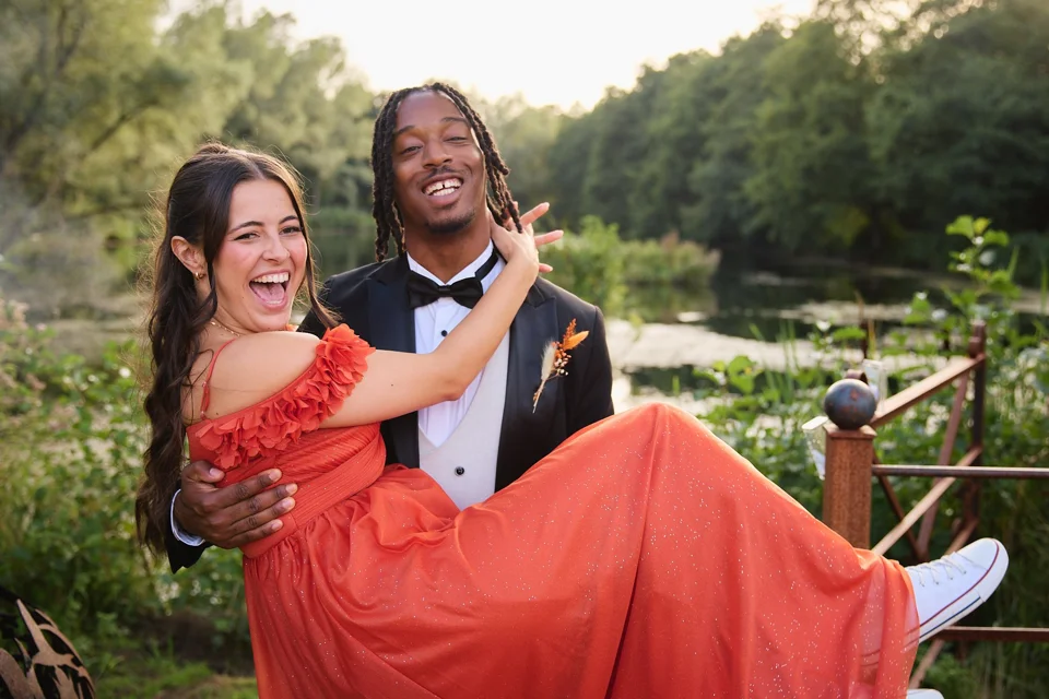 A guest carrying a friend in a red dress