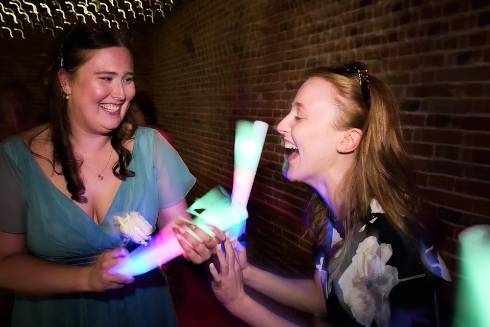 Friends celebrating with glowing party sticks