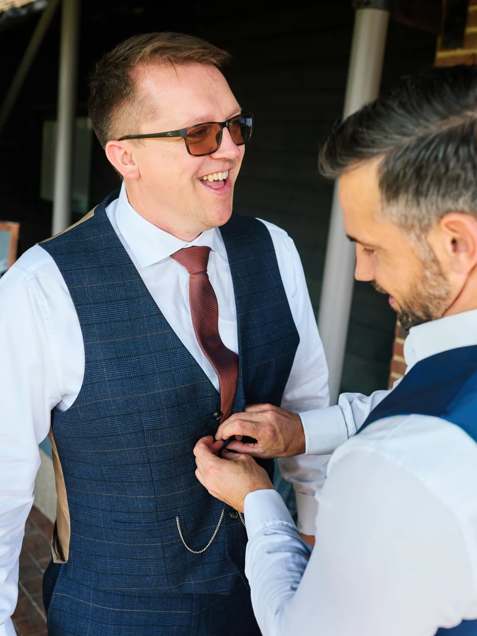 The groom getting ready with a friend